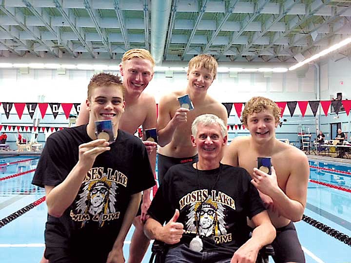 Left to right: Brenden Eslick, Madison Molitor, Zack Johnston and Kaelan Connacher celebrate with head coach Tony St. Onge after the district swim meet in 2014.