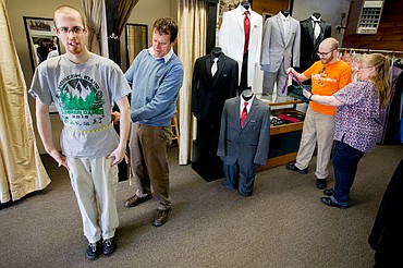 <p>As Touchdown Tuxedo owner Steve Wasson measures Trevor Kirsebom's waist, Steven Kirsebom gets his mother Deena's opinion on a purple tie on Friday, Feb. 5, 2016 at Touchdown Tuxedo in Post Falls. Every year, Wasson offers discounts on clothing rentals to attendees of the Night to Shine prom, a dance sponsered by the Tim Tebow Foundation for people with physical and mental disabilities.</p>