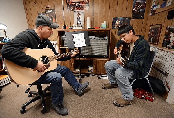 &lt;p&gt;Greg Kerzman, left, works with Howard Woodworth, 14, of Kalispell, on his first guitar lesson on Tuesday afternoon, February 5, at Music One Workshop in Kalispell. Kerzman has been with Music One for nine years. (Brenda Ahearn/Daily Inter Lake)&lt;/p&gt;