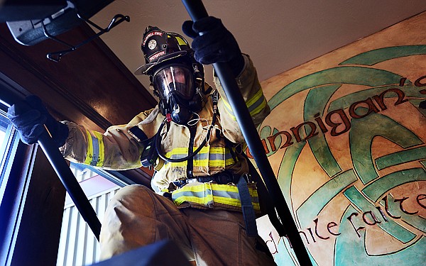 &lt;p&gt;Taylor Zachary of the Kalispell Fire Department wears his gear as he does a round of stair climbing at Brannigan&#146;s Pub on Saturday in Kalispell. Firefighters were at the pub as part of a fundraising campaign. Zachary and five other firefighters will compete in the 22nd Annual Scott Firefighter Stairclimb in Seattle on March 10. The firefighters are paying their own registration and travel expenses. All money raised goes to the Leukemia &amp; Lymphoma Society. The next fundraiser is Feb. 13 at the Tamarack Brewing Co. in Lakeside.&lt;/p&gt;