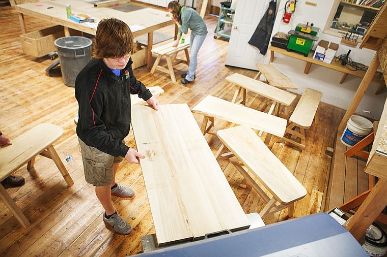 &lt;p&gt;Freshman Jake Bedoian loads a board of American elm through a planer Thursday morning at Flathead High School. The board will serve as the the top of a bench Bedoian is making in wood shop. Last semester the class made 98 benches out of the dead elm trees that were removed from Kalispell neighborhoods.&lt;/p&gt;