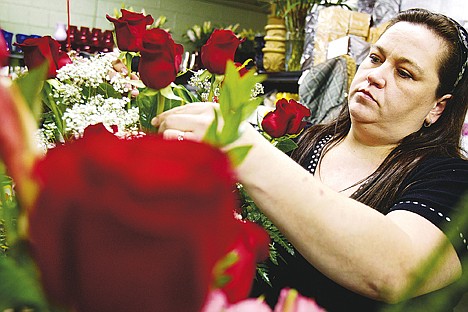 &lt;p&gt;Danielle Hansen, owner of Hansen's Florist and Gifts, prepares one of the hundreds of pre-ordered Valentine's Day floral arrangement Monday at her storefront in Coeur d'Alene.&lt;/p&gt;