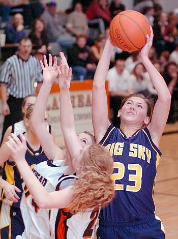 MISSOULA Big Sky freshmen Elleson Tinkle takes the rebound from Flathead Bravettes Marissa Stivers and Samantha Thompson during the first half of Thursday's game at Flathead. Allison Money/Daily Inter Lake