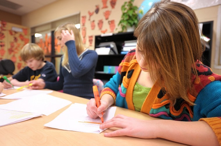 Meryl Crabtree and members of her Destination ImagiNation team work on the script for their skit.