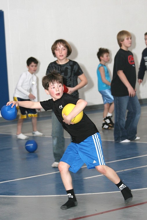 Kaleb Ververis winds up for a dodge ball toss during a kick-off dodgeball tournament for Little Guy Wrestling in Superior last Tuesday.