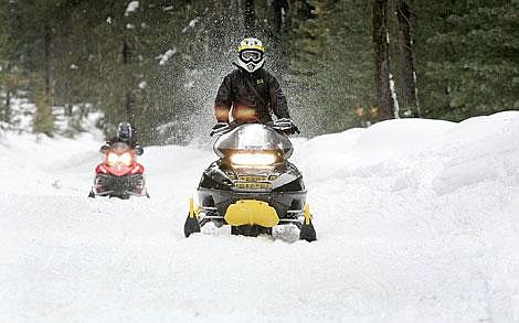 Photo by Ed Moreth&lt;br&gt;Snowmobilers finish up the poker run ride at the edge of Marten Creek near Trout Creek. Two hundred and nine riders took part in this year's Cabinet Ridge Riders Poker Run. The snowmobile group gives thousands of dollars each year in scholarships, school sports, senior centers, and Girl Scouts.