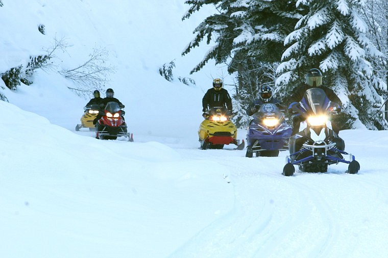 Bill Rounds leads a group of snowmobile riders from Mullan up to Lookout Pass during the Montana Night Riders Annual Poker Run Saturday afternoon. More than 300 riders turned out for the 21st annual poker ride Saturday.