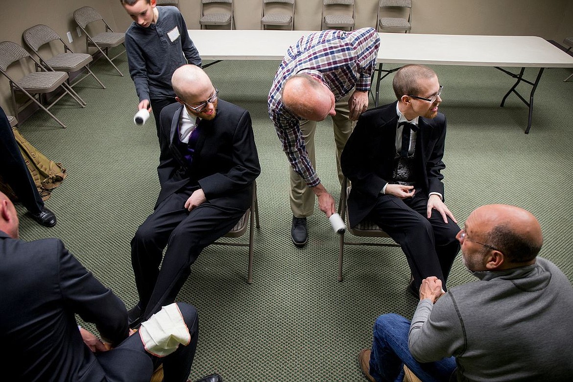 &lt;p&gt;JAKE PARRISH/Press Steven, left, and Trevor Kirsebom have their shoes shined and tuxedos cleaned before they meet their dates at the Night to Shine prom on Friday at Real Life Ministries in Post Falls.&lt;/p&gt;