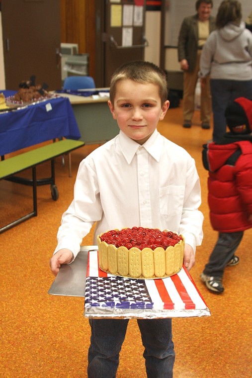 Charlie Rehbein shows off his cake which won the award for most creative. It went for $20 at the Feller's Cake Bake Feb. 5.