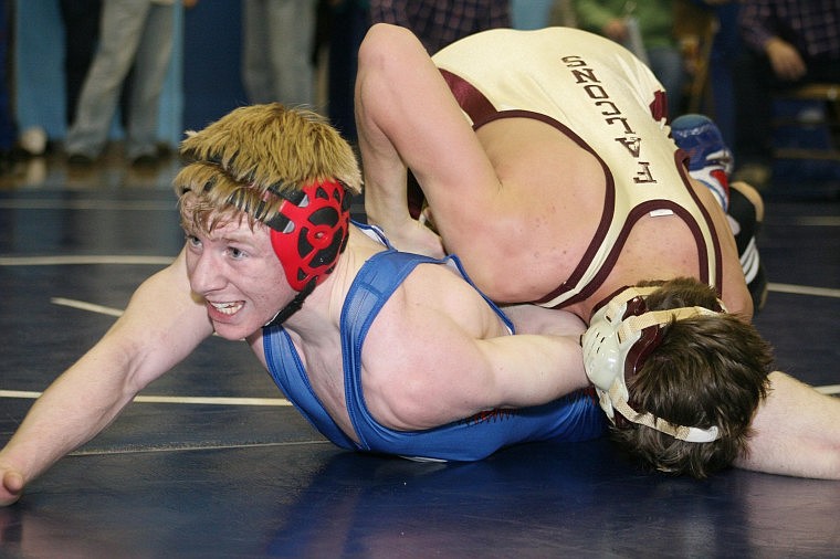 Superior's Garret Stephens wrestles Florence's Zach Newbary in the second round at 130 pounds during divisionals.