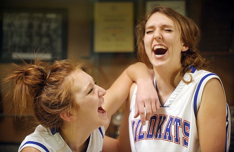 Kayla and Kelsey DeWit share a laugh at Columbia Falls High School on Monday. The sisters lead the Northwestern A conference in scoring and rebounding and have helped the Wildkats to a 9-5 start on the basketball season.