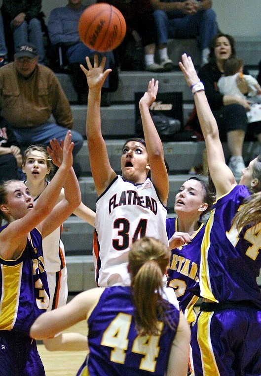 Flathead's Brittany Earnest lets go of a shot while surrounded by four Missoula Sentinel Lady Spartans in the second half of Thursday evening's game in Kalispell. Earnest led the Bravettes in scoring with ten points.