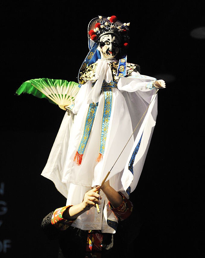 <p>Song Dongqing performs the Changing Masks puppet show. Face changing is a popular stage technique way to display the complex emotions of the characters. (Aaric Bryan/Daily Inter Lake)</p>