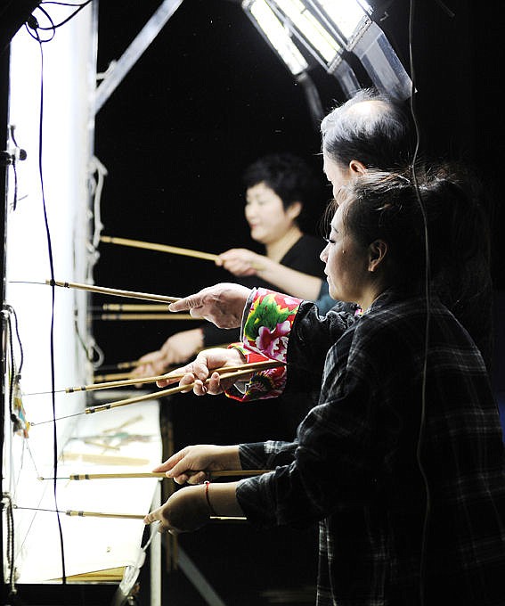 <p>Members of the Shannxi Folk Arts Group of Xian, China perform shadow puppetry. Chinese shadow puppets show are very intricate and take a lot of team work. (Aaric Bryan/Daily Inter Lake)</p>