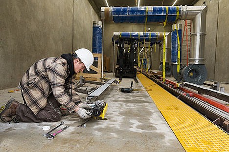 &lt;p&gt;Josh Hatcher, who will be the assistant manager after the car wash opens, works on assembling hydraulic parts near the exit of the car wash.&lt;/p&gt;