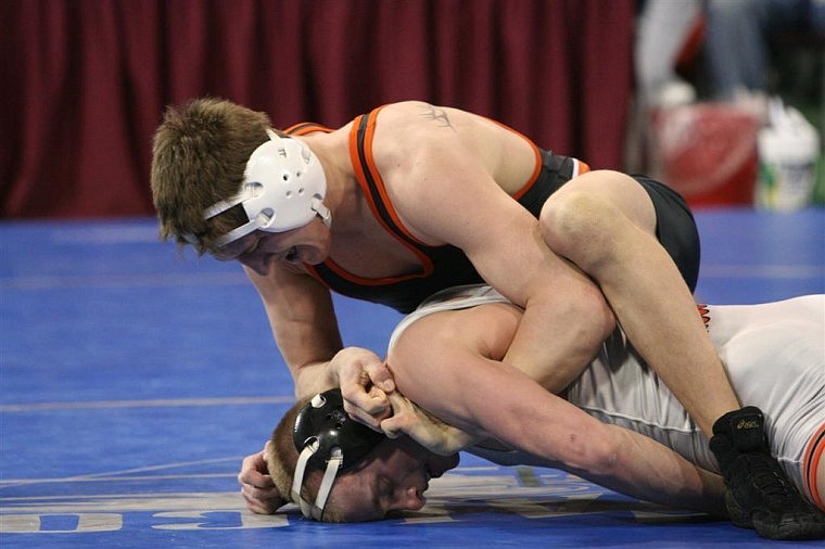 Flathead&#146;s Shawn Lau wrestles Ben Sulser of Billings Senior in the Class AA 140-pound state championship match. Lau claimed a 5-0 decision and is now a three-time state champion.