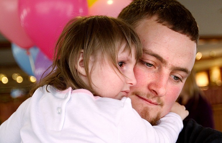 Tasha is held by her father, Reuben, before leaving Pizza Hut.