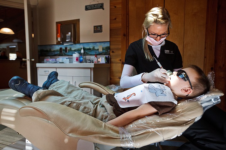 &lt;p&gt;SHAWN GUST/Press Kami Nielsen, dental hygienist for Avondale Dental Center, cleans the teeth of five-year-old Jacob Osterdock Friday during the Give Kids a Smile Day. The event, in its ninth year, offers tens of thousands of dollars worth of dental work to uninsured children at no cost each year.&lt;/p&gt;