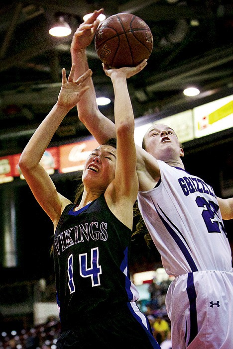 <p>Coeur d'Alene High's Brittany Tackett is hit in the head from behind by the arm of Megan Hochstein from Rocky Mountain.</p>