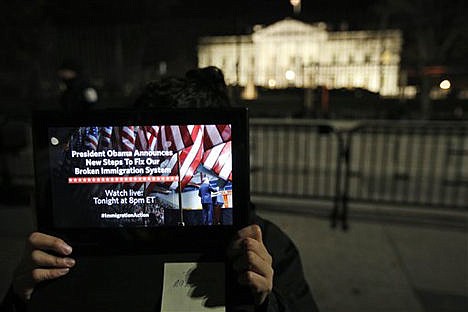 &lt;p&gt;A supporter holds a tablet in front of the White House in Washington during a demonstration before President Obama's immigration address on Nov. 20.&lt;/p&gt;