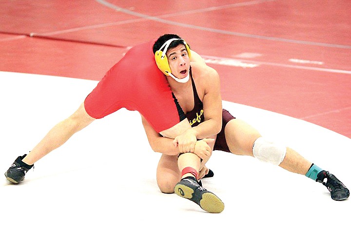 Facing a win or lose situation to get to state, Moses Lake's Jonathan Perales (right) took third place in his final match at the Region IV tournament on Saturday to advance on to Mat Classic XXIII.