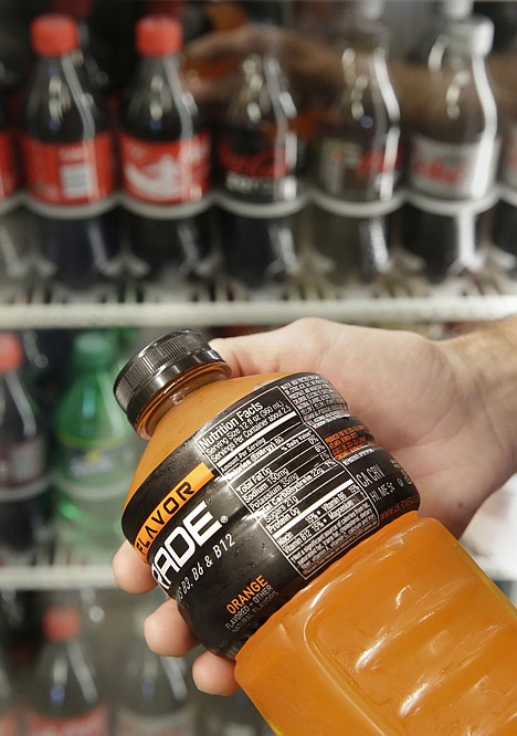 &lt;p&gt;Nicholas Wray displays a content label on an energy drink that might be required to add a warning about the dangers of consuming sugary drinks under proposed legislation in Sacramento, Calif., Thursday.&lt;/p&gt;