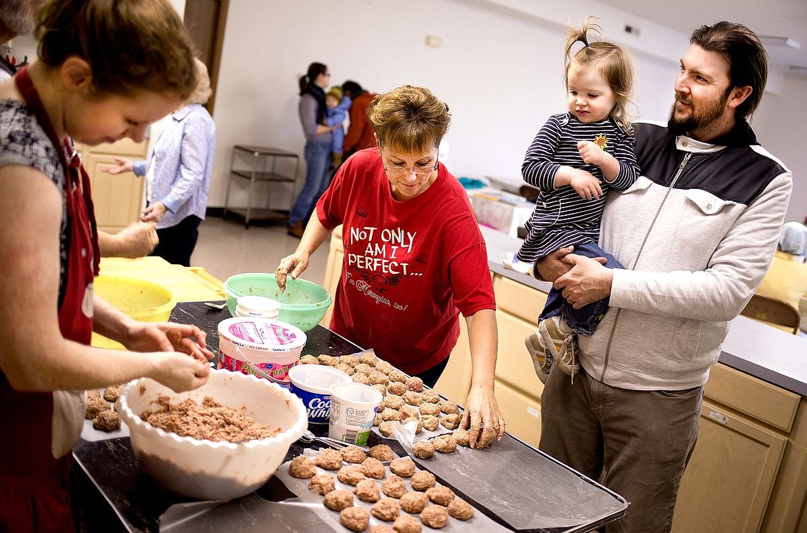 &lt;p&gt;JAKE PARRISH/Press With the help of her father Bjorn Handeen, Saga, 2, watches her mother Holly, left, and Cindy McManus, center, make traditional Norwegian meatballs on Friday in preparation for the Sons of Norway annual Lutefisk and Lefse Dinner. The dinner will take place on Feb. 21 at the Independent Order of the Odd Fellows in Post Falls, and reservations must be made by Feb. 17.&lt;/p&gt;