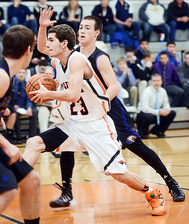 &lt;p class=&quot;p1&quot;&gt;Flathead senior Chandler Escalante (23) splits a pair of Missoula Big Sky defenders on his drive to the basket Saturday at Flathead High School. (Brenda Ahearn/Daily Inter Lake)&lt;/p&gt;