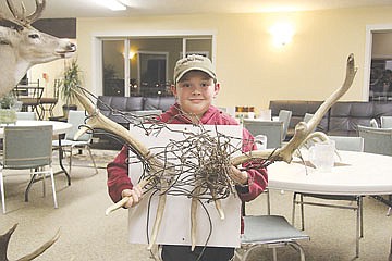 &lt;p&gt;Malachi Warneke of Polson shows off antlers dropped by an elk in Judith Basin. Prior to shedding its rack, the elk had been entangled in the wires shown.&lt;/p&gt;