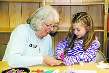 &lt;p&gt;&#151;Photo by LAURA ROADY&lt;/p&gt;
&lt;p&gt;Librarian Jan Allen helps Marissa Beggerly create a snowflake puzzle during a winter reading program workshop.&lt;/p&gt;