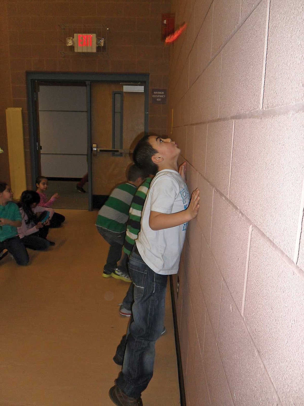 Malaki Towne, a second grader, plays &quot;Float Around,&quot; keeping the feather in air as long as possible, using only his breath.