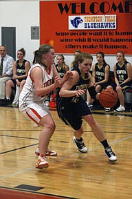 Sophomore forward Hope Reid drives baseline against Kayla Revier during the Trotters' senior night on Friday.