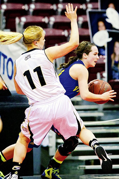 <p>Coeur d'Alene High's Sydni Parker drives the baseline past Khadija Neumeyer from Capital High.</p>