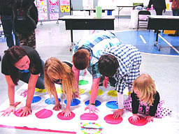 Superior students partake in a game of twister.