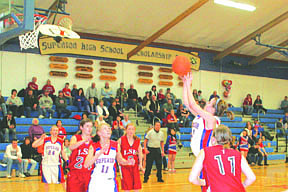 Ashley Blaylock tries to take the ball to the basket as Kelsey Stenberg looks on, ready to rebound.