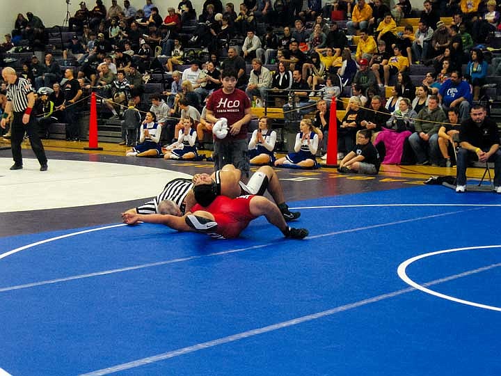 Eduardo Ortiz of Wahluke, squeezes down and scores a pin over a wrestler from Granger during consolation matches. He made it to the fifth-place match but did not advance to state.