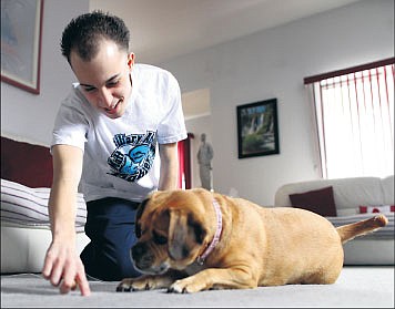 &lt;p&gt;In this photo taken Feb. 12, Matthew Rosiello plays with the family dog, Holly, at his home in New York.&lt;/p&gt;