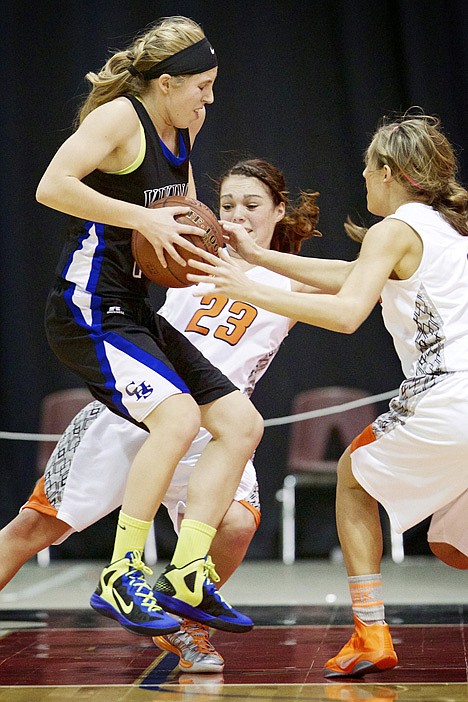 &lt;p&gt;Coeur d'Alene High's Caelyn Orlandi leaps in between Brooke Litalien, background, and Shayna Allert from Post Falls High.&lt;/p&gt;