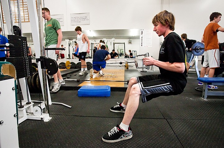 Andrew Miller works out on a lat-pull machine while conditioning the muscles in his back.