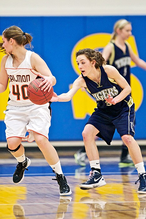 <p>Timberlake High's Ashly George reaches in for a steal from Tess McClenahan from Salmon High during the first half Thursday's game at Middleton High in Middleton, Idaho.</p>