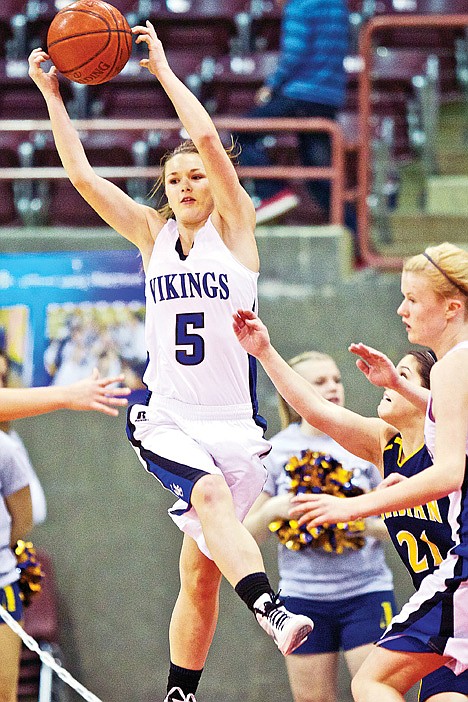 <p>Coeur d'Alene High's Sara Chalich jumps for a high pass at the baseline during the second half.</p>