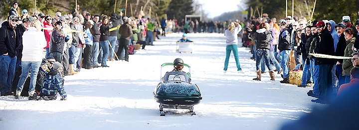 &lt;p&gt;Mark McConnaughey of Kalispell, representing the Boosefighters Motorcycle Club, successfully completes his run in the Barstool Ski Races on Saturday during the 36th Annual Cabin Fever Days in Martin City.&lt;/p&gt;