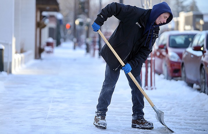 &lt;p&gt;Dean Moore clears up the new snowfall in front of Charter Communications on Tuesday, February 11, in downtown Kalispell. (Brenda Ahearn/Daily Inter Lake)&lt;/p&gt;