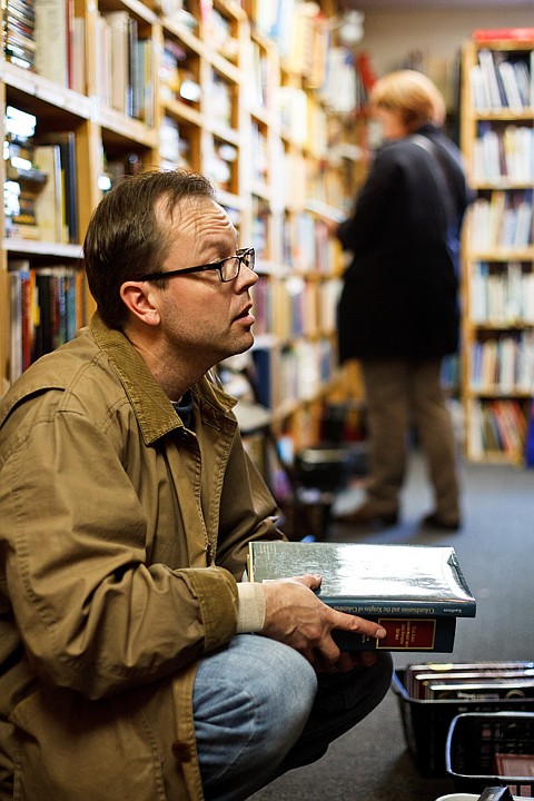 &lt;p&gt;Scott Blomquist looks over titles Thursday at Browsers Uncommon Books in Coeur d'Alene.&lt;/p&gt;