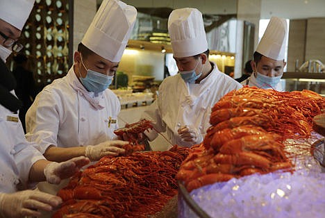 &lt;p&gt;In this Feb. 9 photo, Chinese chefs prepare Boston lobsters at the Auspicious Garden restaurant in Pangu Seven Star Hotel in Beijing.&lt;/p&gt;