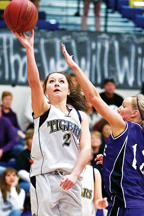 <p>Timberlake High's Kara Wenstrom elevates to the basket in front of Shayla Christensen from Snake River.</p>
