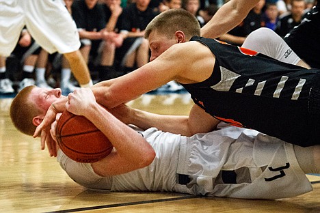 &lt;p&gt;Michael Hillman, of Post Falls High, lands on Lake City's Kyle Guice while chasing a loose ball Friday in the second half of the 5A Region 1 basketball tournament in Coeur d'Alene.&lt;/p&gt;