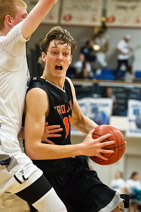 <p>Post Falls' Seth Anderson drives passed a Lake City defender in the third quarter.</p>