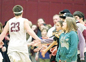 &lt;p&gt;Fans congratulate after Trojans pull out a 64-61 'squeaker' over Mission Saturday.&lt;/p&gt;