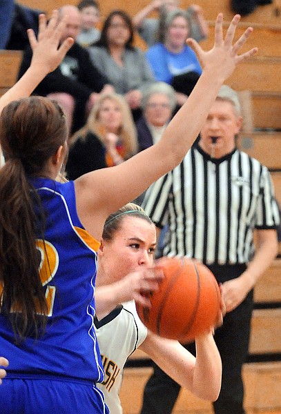 Whitefish freshman Molly Crick, 40, tries to position herself for a shot under pressure from Libby senior Alysha Martin, 22, during their game on Thursday night in Whitefish.
